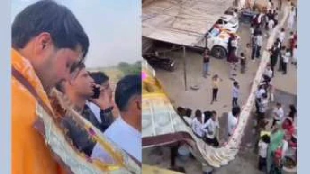 పెళ్లిలో వరుడి కోసం 100 అడుగుల నోట్ల దండ; అన్నీ 500 నోట్లే.. దండ వేసుకోవడానికి నిచ్చెన ఎక్కిన పెళ్లికొడుకు!